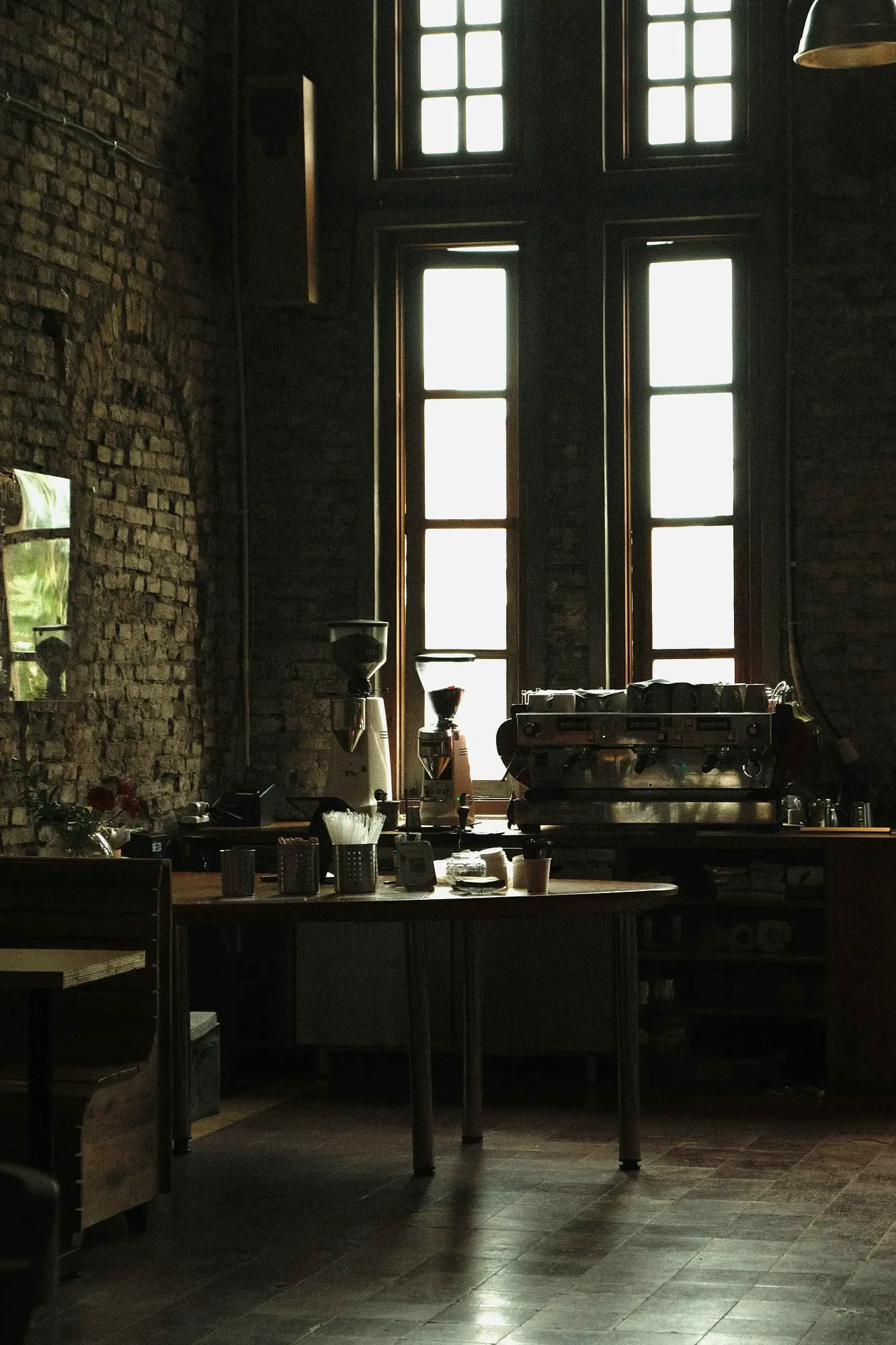 The Sourwood coffee bar in the morning, brick wall and espresso machine by the window